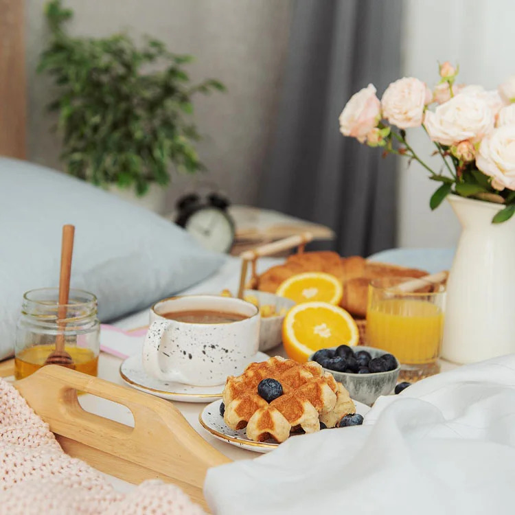 Luxury breakfast with croissants, coffee, and flowers